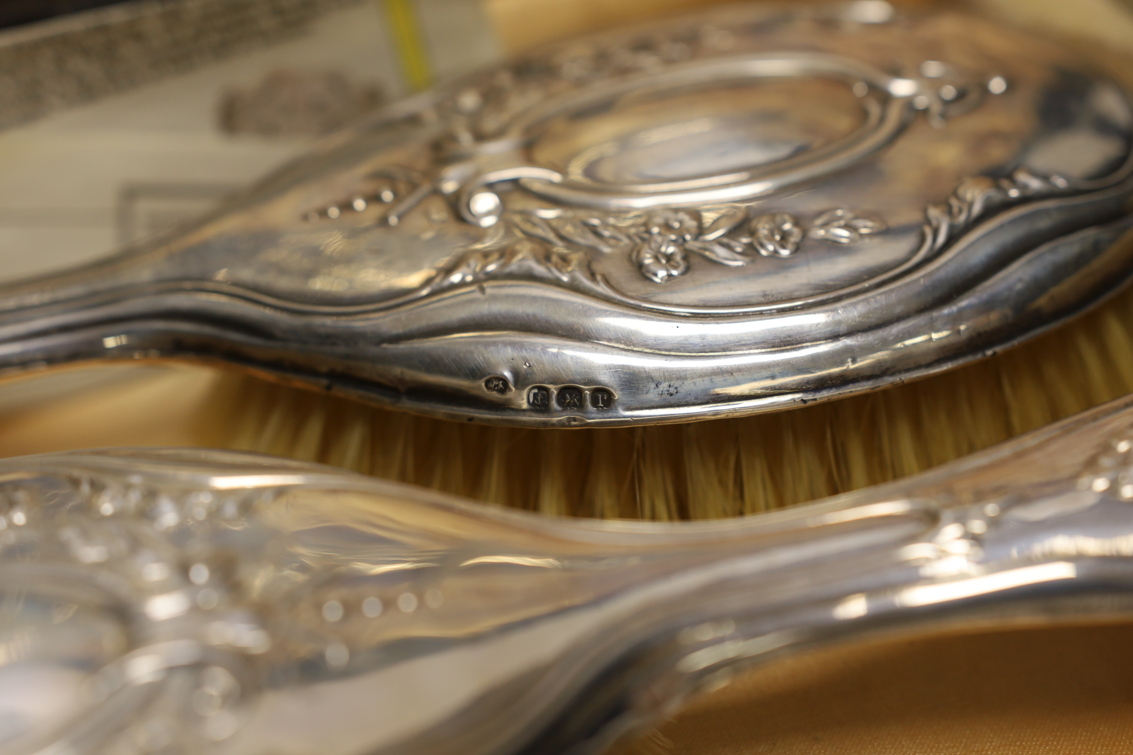 A cased silver four piece dressing table set.